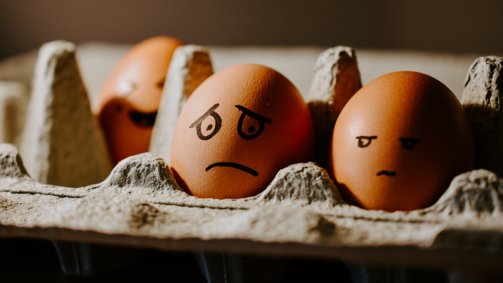 Image of eggs in an eggbox with a frown depicting excessive worry